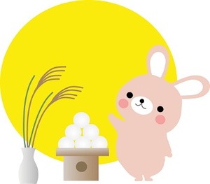 イラスト：満月を背景に、ウサギがお月見団子とススキを並べてお月見している様子