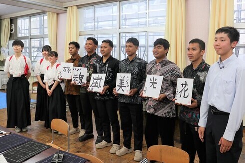 写真：完成した作品を手に記念撮影する技能実習生と波崎高校の生徒