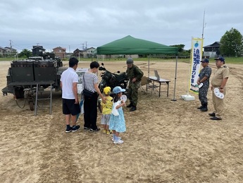写真：自衛隊車両について説明を受ける市民