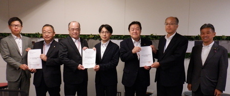 写真：2025年7月24日国土交通省にて撮影。国土交通省道路局長へ要望書を渡しているようす。
