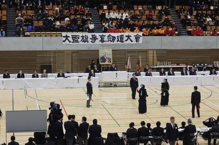 写真：会場の全景を写した写真。正面の来賓席中央には、元國士舘大学剣道部長、剣道範士九段・大野 操一郎先生の遺影が飾られている